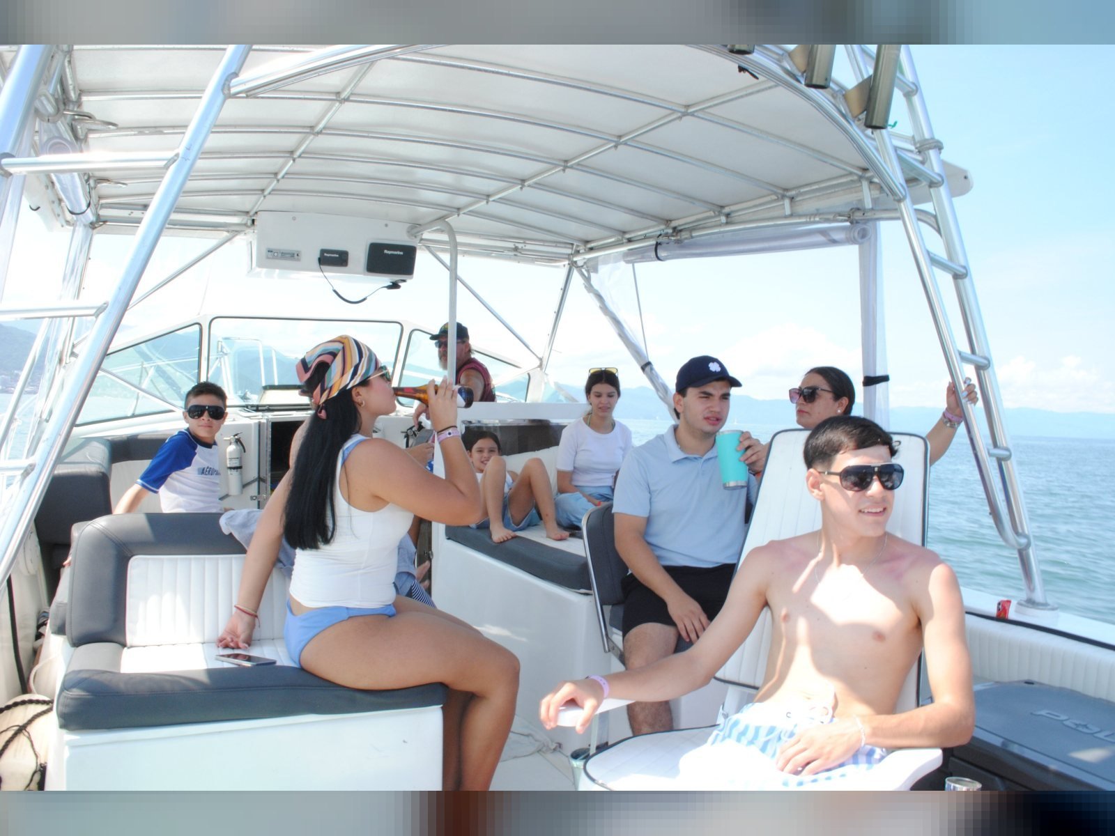 A group celebrating under the shade canopy on a private charter out of Nuevo Vallarta